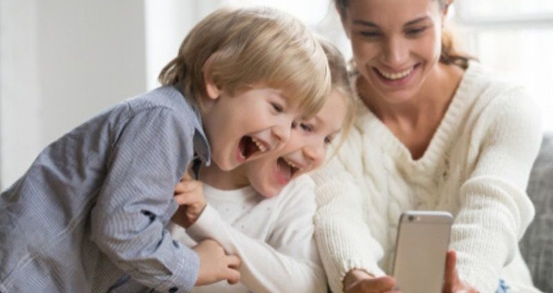 young mom taking selfie with kids