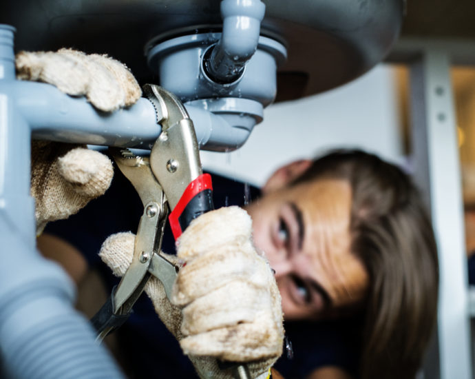 Man fixing kitchen sink